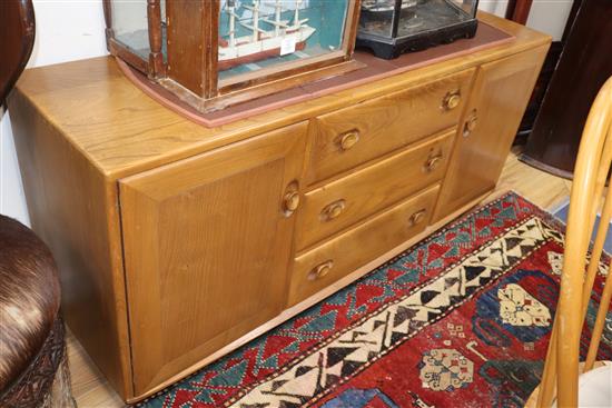An Ercol dining table and chairs, and a sideboard 150cm, 155cm
